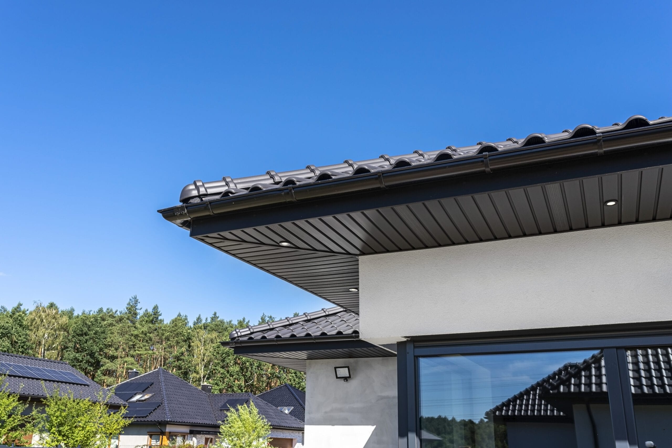 A modern graphite herringbone roof lining is attached to the trusses, visible turned on LED lights.