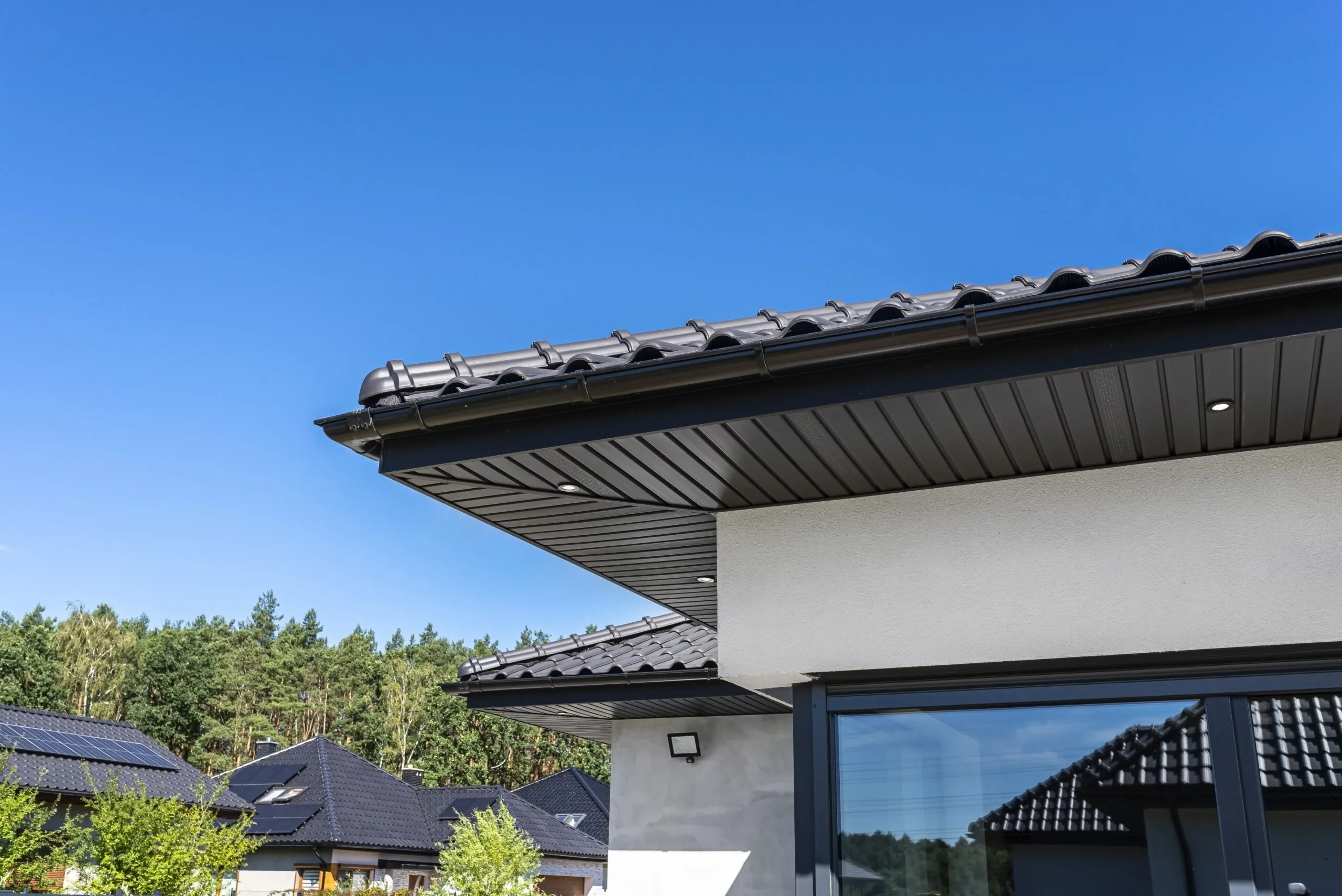A modern graphite herringbone roof lining is attached to the trusses, visible turned on LED lights.